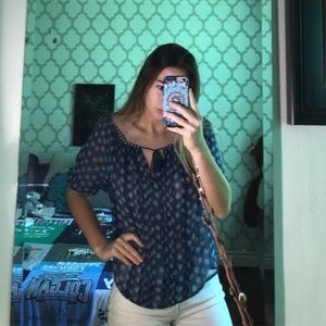 Sheer blue blouse with a tie in the front.